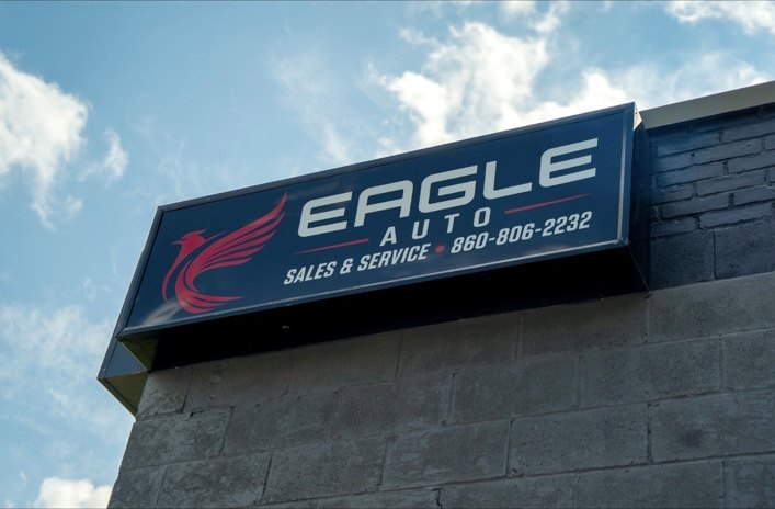 Red eagle logo on Eagle Auto Sales and Service exterior building sign, Torrington Connecticut